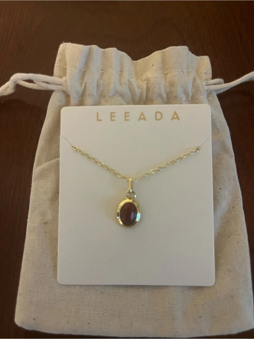 Gold Necklace with Burgundy Oval Gemstone Pendant